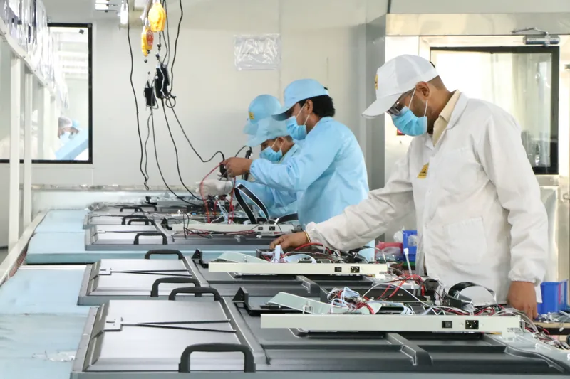 StudynLearn technicians assembling PCB display panels on the in-house CKD integration line